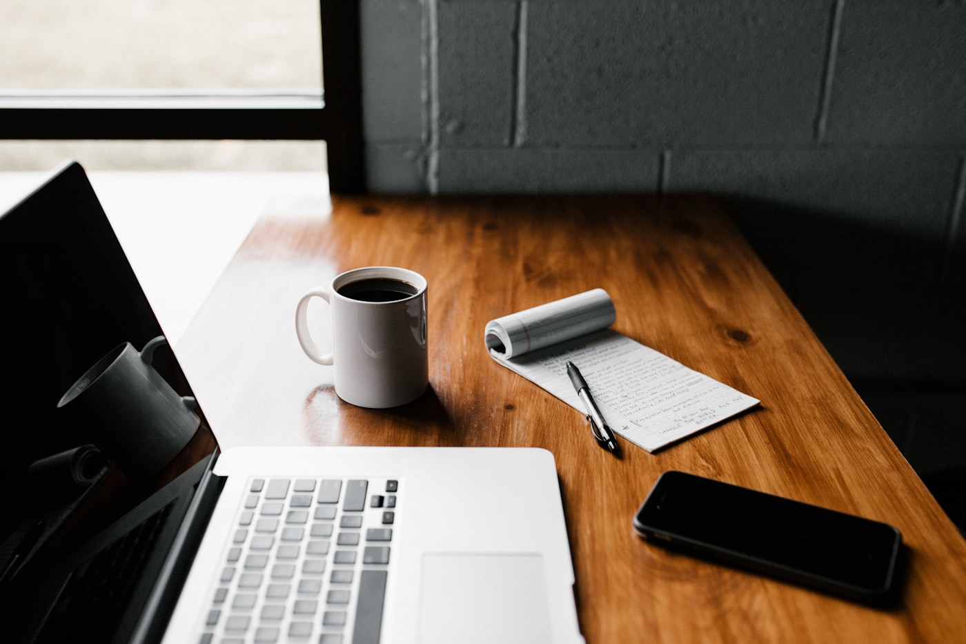 Notebook, pen and laptop on a wooden desk — planning a 30-day career change