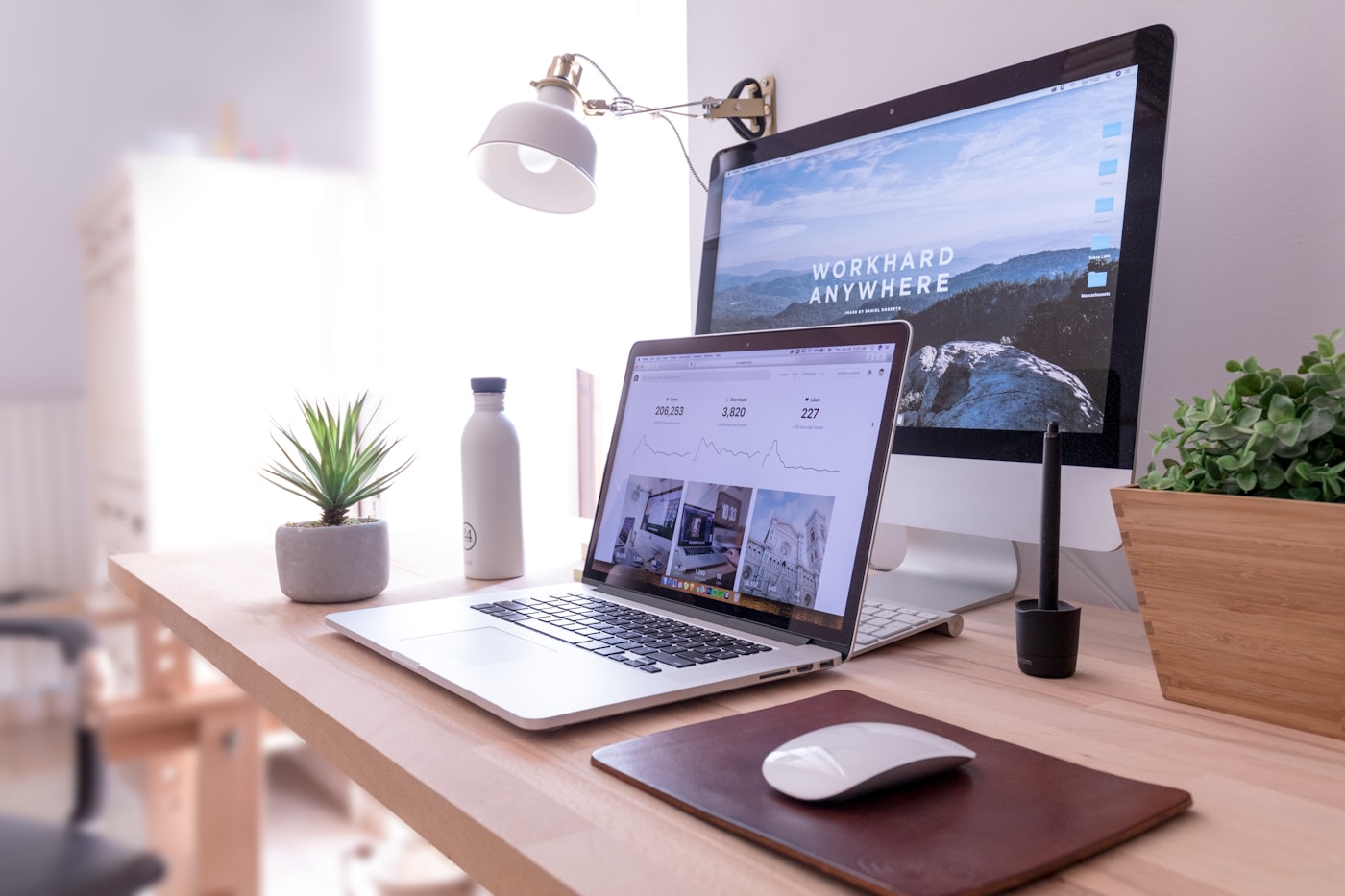A tidy home-office desk with a laptop and monitor — a free job-search setup